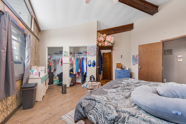bedroom with ceiling fan, lofted ceiling with beams, and light hardwood / wood-style flooring