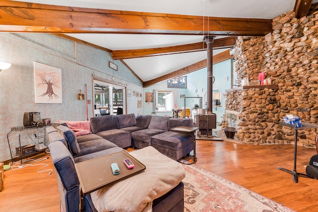 living room with hardwood / wood-style flooring and lofted ceiling with beams