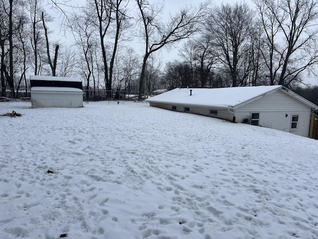 snowy yard with an outdoor structure