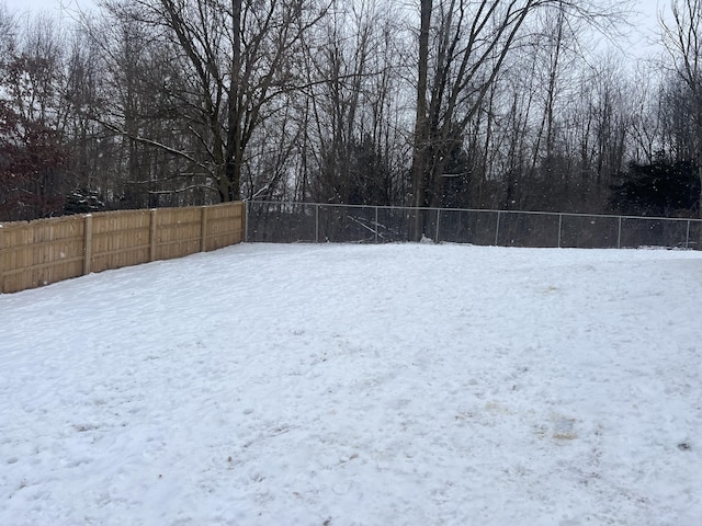 view of yard layered in snow