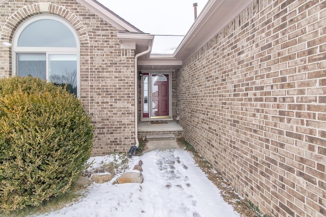 view of snow covered property entrance