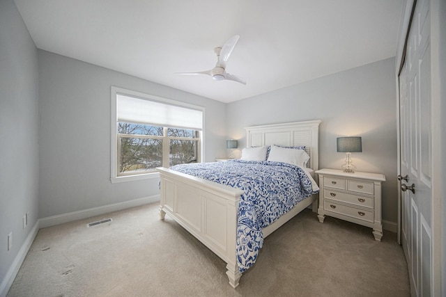 carpeted bedroom with ceiling fan and a closet