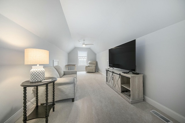 living room featuring ceiling fan, light carpet, and vaulted ceiling