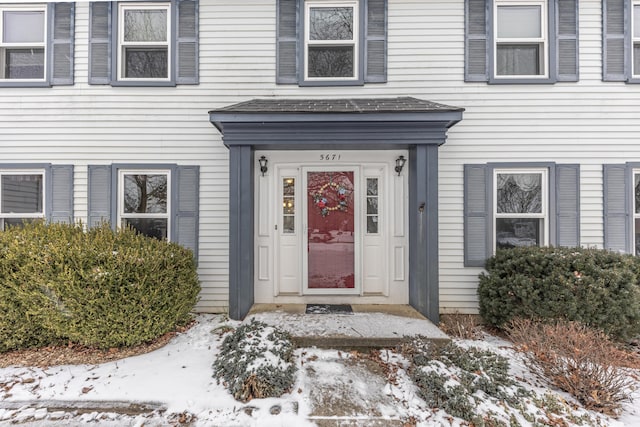 view of snow covered property entrance