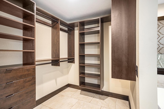 walk in closet featuring light tile patterned flooring