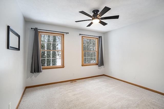 carpeted empty room featuring ceiling fan