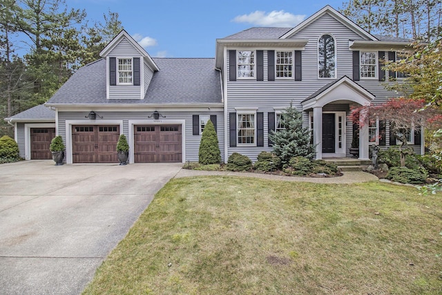 view of front of property with a front lawn and a garage