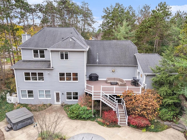 rear view of property featuring an outdoor hangout area and a wooden deck