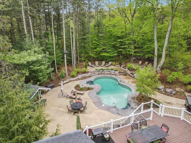 view of swimming pool with a wooden deck