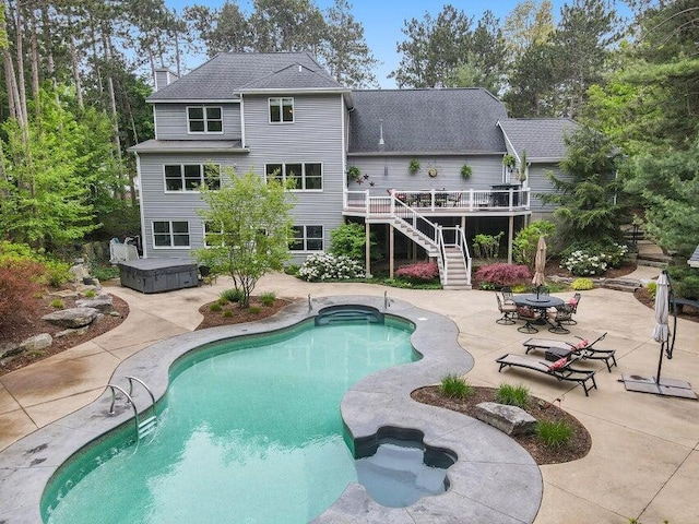 view of pool featuring a wooden deck and a patio