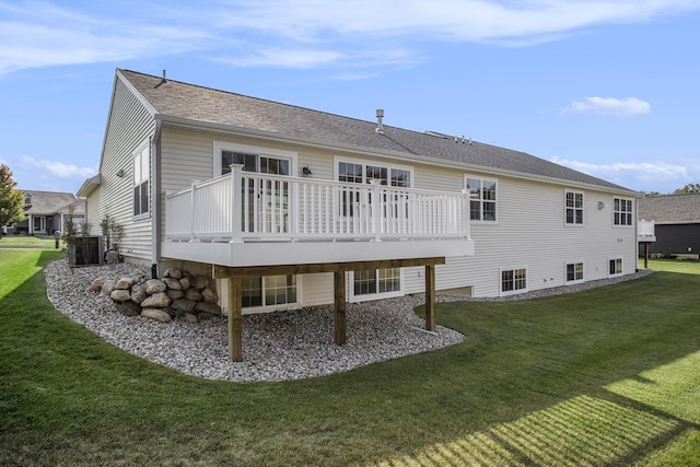 rear view of property featuring a lawn, a wooden deck, and central air condition unit