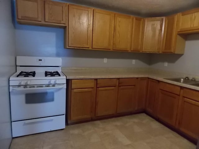 kitchen featuring sink and gas range gas stove