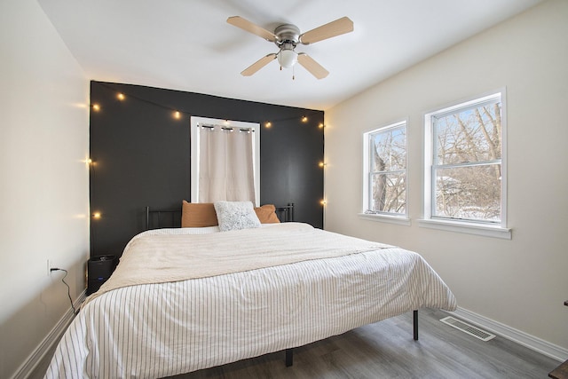 bedroom featuring hardwood / wood-style flooring and ceiling fan