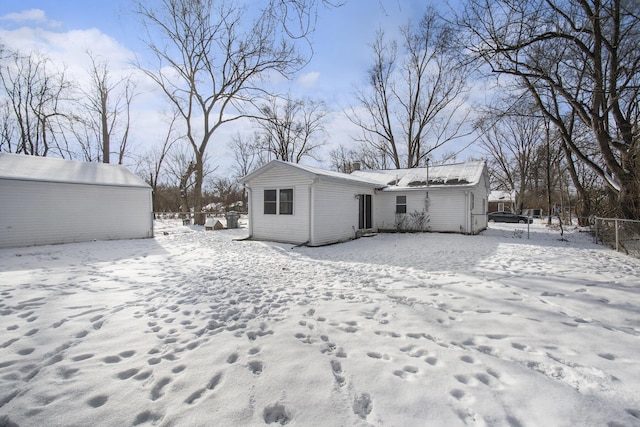 view of snow covered back of property