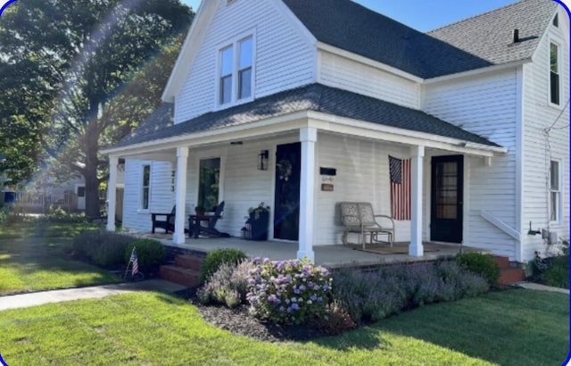 view of front of property with covered porch and a front yard