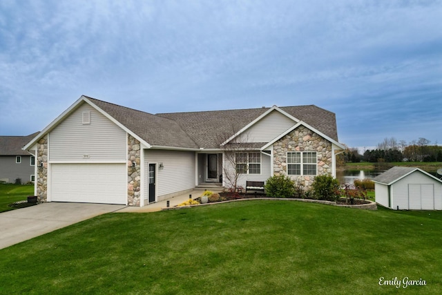 view of front of property featuring a front yard, a garage, and a storage shed