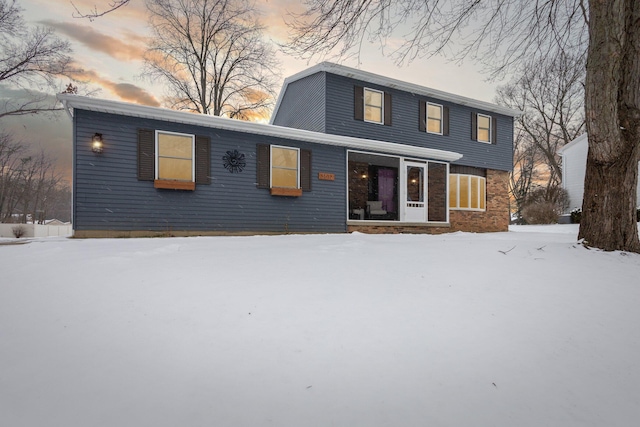 view of snow covered rear of property