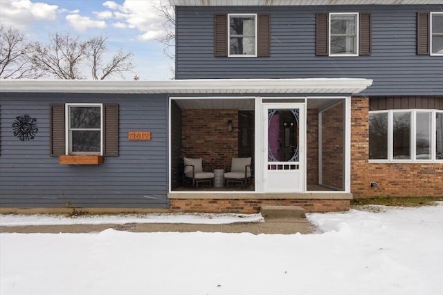 view of snow covered property entrance