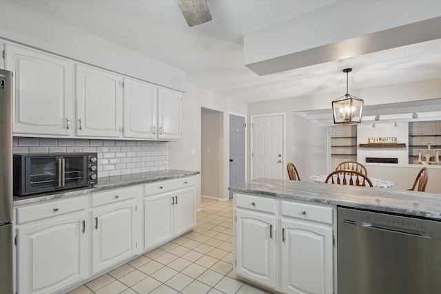 kitchen with white cabinetry, dishwasher, light tile patterned floors, decorative backsplash, and pendant lighting