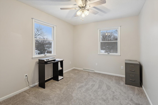 interior space with a healthy amount of sunlight, a textured ceiling, ceiling fan, and light colored carpet