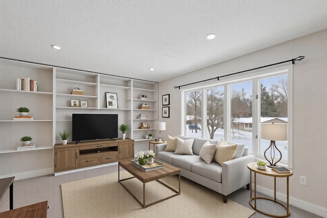 carpeted living room with a textured ceiling