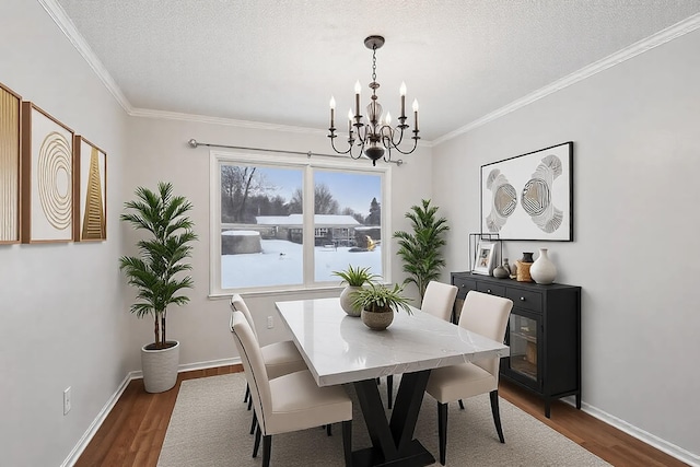 dining area featuring dark wood-type flooring, an inviting chandelier, and a textured ceiling