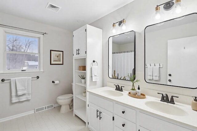 bathroom with toilet and vanity