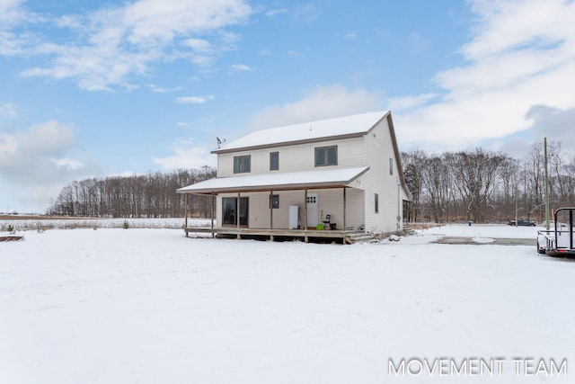 snow covered house with a porch