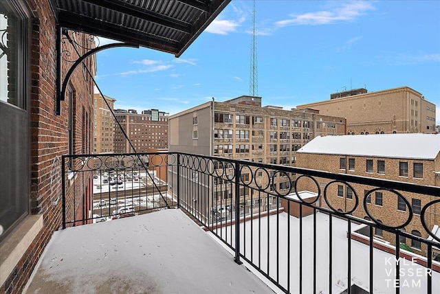 view of snow covered back of property