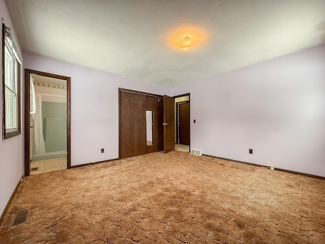 unfurnished bedroom with carpet and a closet