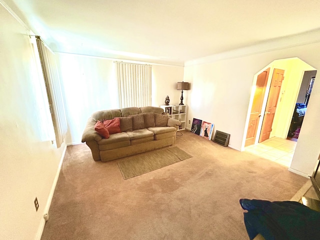 carpeted living room featuring crown molding