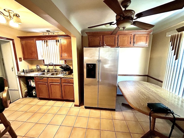 kitchen with light tile patterned flooring, stainless steel fridge with ice dispenser, ceiling fan, and sink