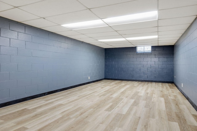 spare room with light wood-type flooring and a paneled ceiling