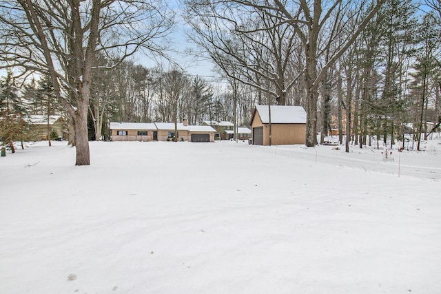 yard covered in snow with a garage