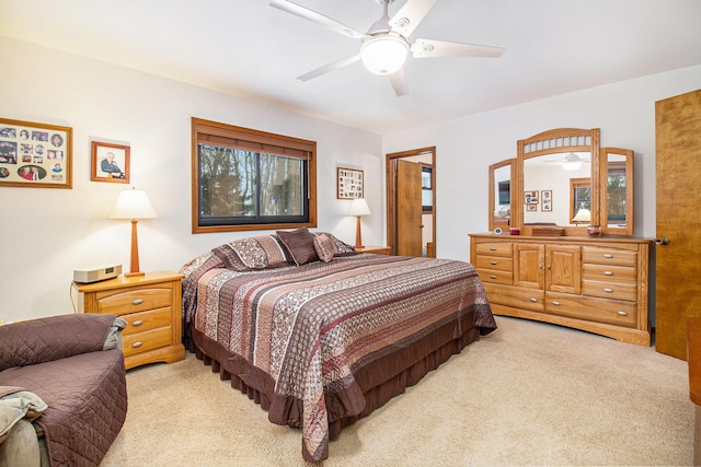 bedroom featuring light carpet and ceiling fan