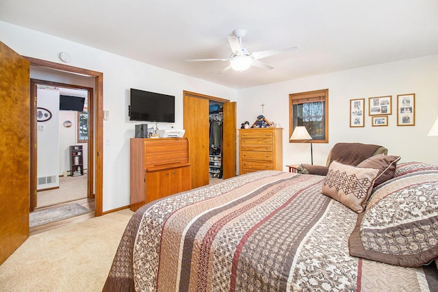 carpeted bedroom with ceiling fan and a closet