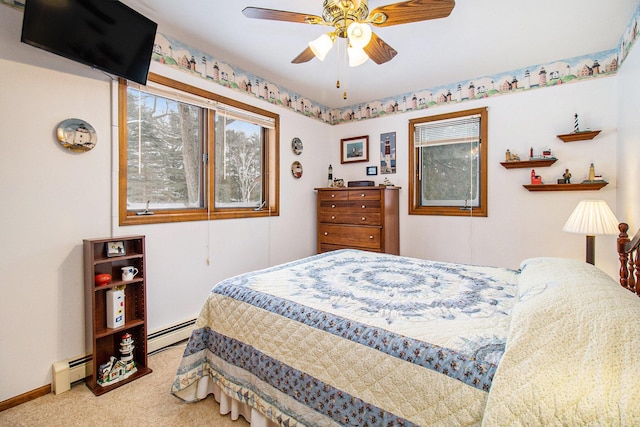 bedroom with ceiling fan, a baseboard radiator, and carpet flooring