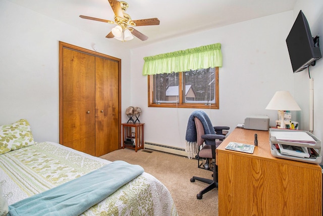 carpeted bedroom featuring a baseboard heating unit, a closet, and ceiling fan