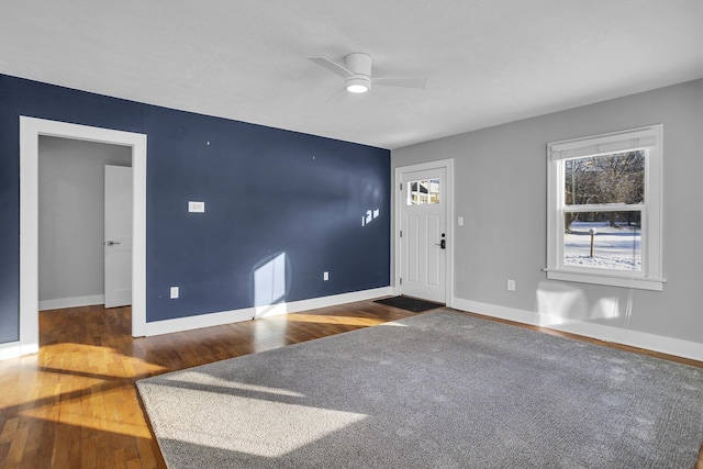 interior space with ceiling fan and dark hardwood / wood-style floors