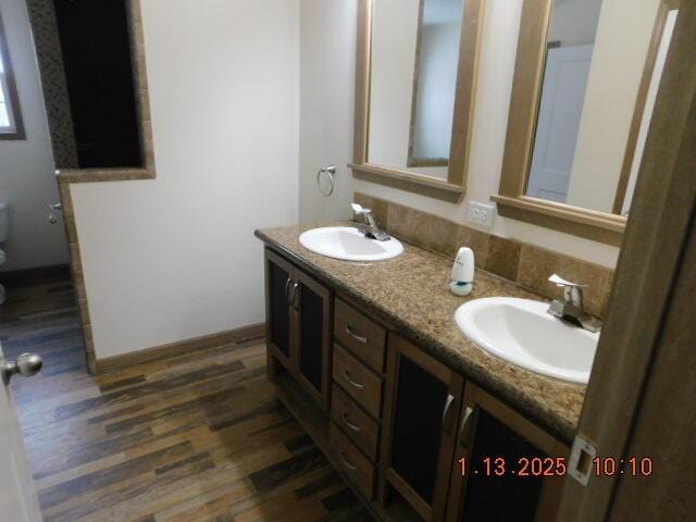 bathroom featuring hardwood / wood-style flooring, vanity, and toilet