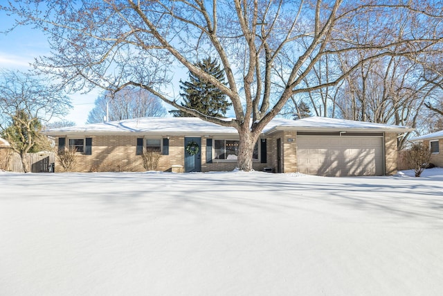 single story home featuring brick siding, fence, and an attached garage