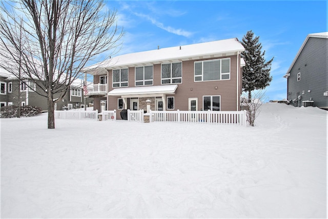 view of snow covered back of property