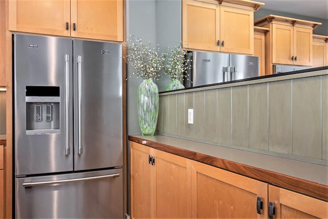 kitchen with light brown cabinets and high end refrigerator