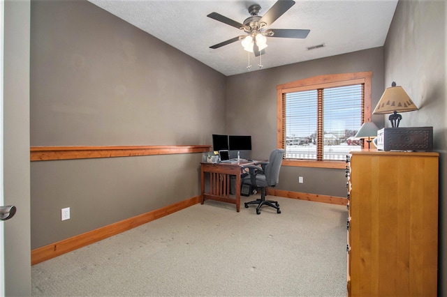 carpeted office space with ceiling fan