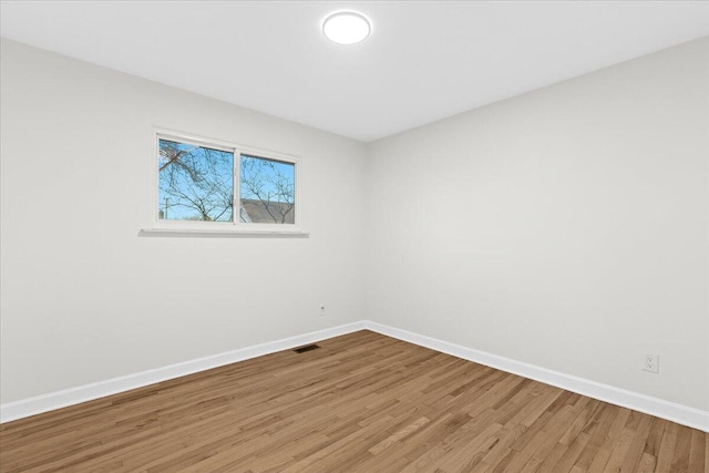 empty room featuring hardwood / wood-style flooring