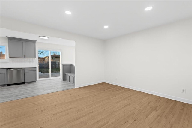 unfurnished living room with plenty of natural light and light hardwood / wood-style floors