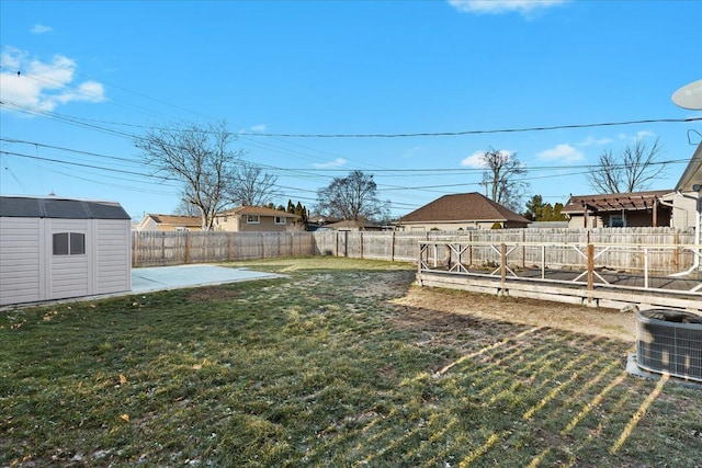 view of yard featuring a storage shed, a patio, and central air condition unit