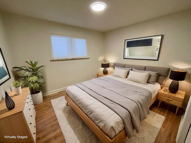 bedroom with hardwood / wood-style flooring