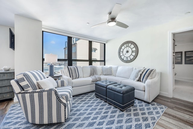 living room with ceiling fan and wood-type flooring