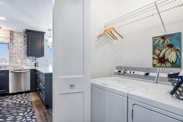 washroom featuring washing machine and dryer and dark hardwood / wood-style floors